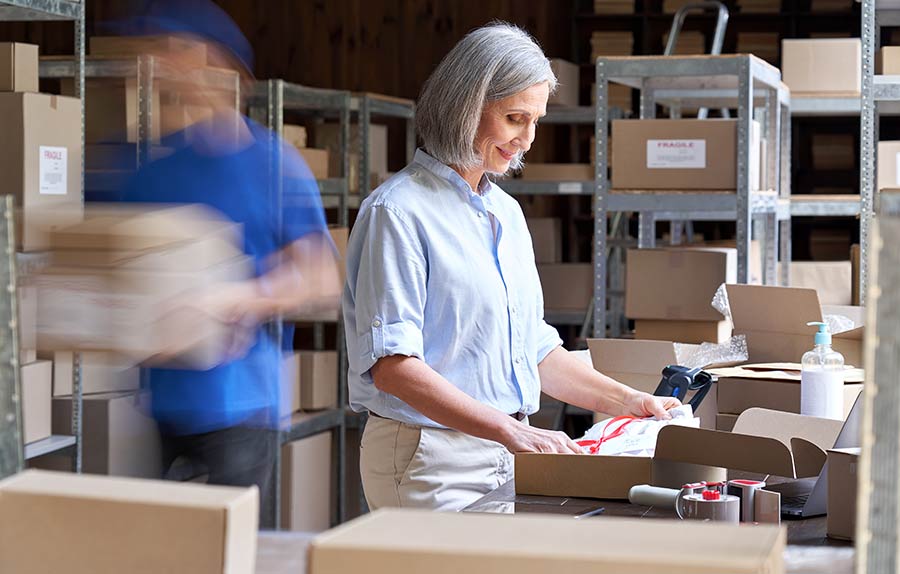 Woman and man packaging orders in Chicago public warehouse