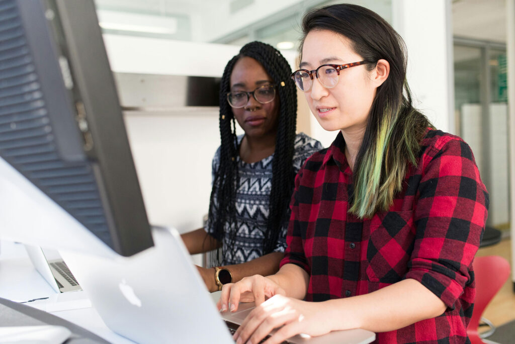 Two women looking at computer